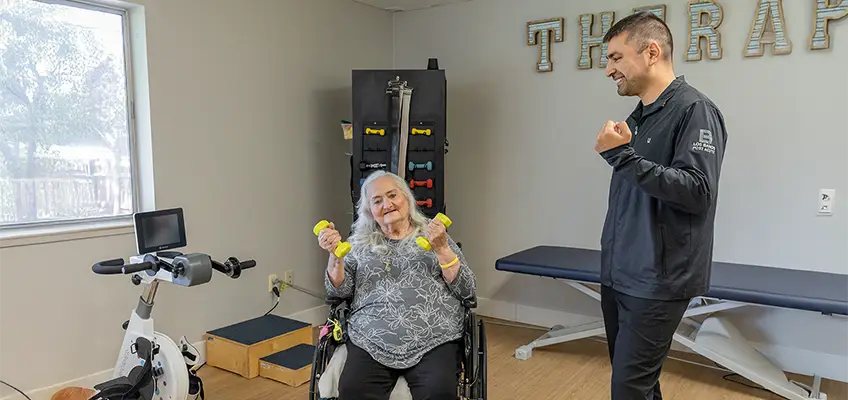 A rehab therapist with a resident in the rehab gym at Los Banos