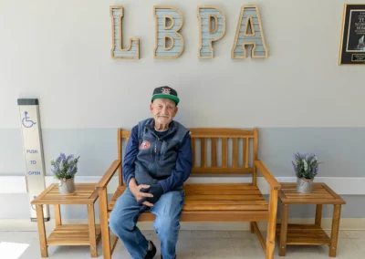 A resident sitting on a bench at Los Banos
