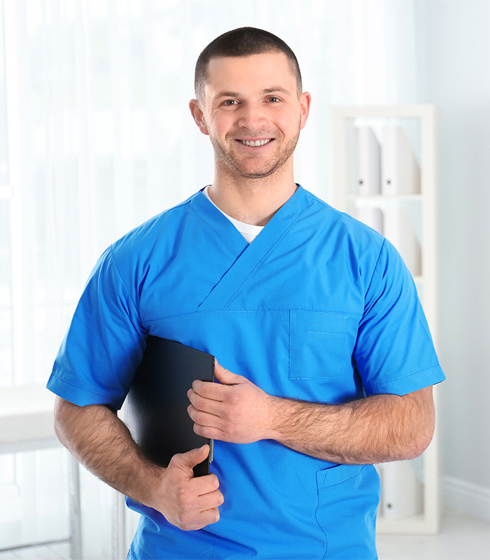 yolo-700x800-18 Male healthcare worker in blue scrubs