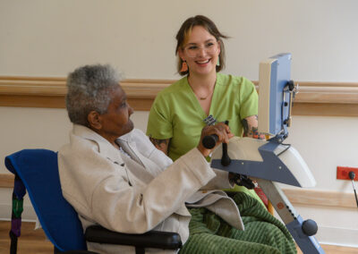 A nurse working with an elderly woman at Carmel Hills