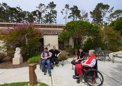 A group of residents out in the courtyard at Carmel Hills