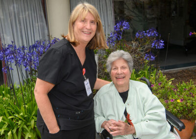 A nurse smiling with an elderly woman at Carmel Hills