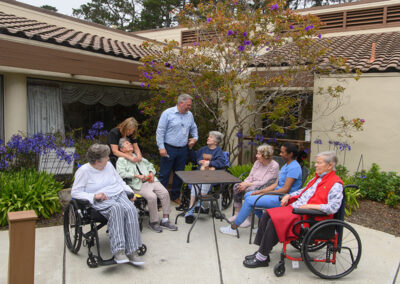 A group of residents sitting outside at Carmel Hills