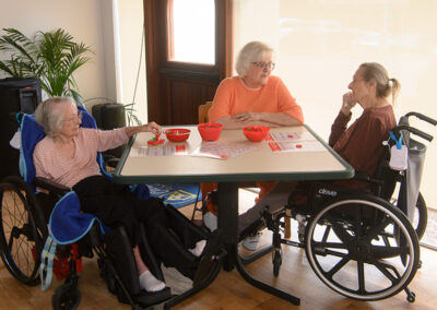 Three residents playing a game together at Carmel Hills