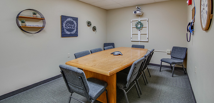 Private meeting room with long table and chairs