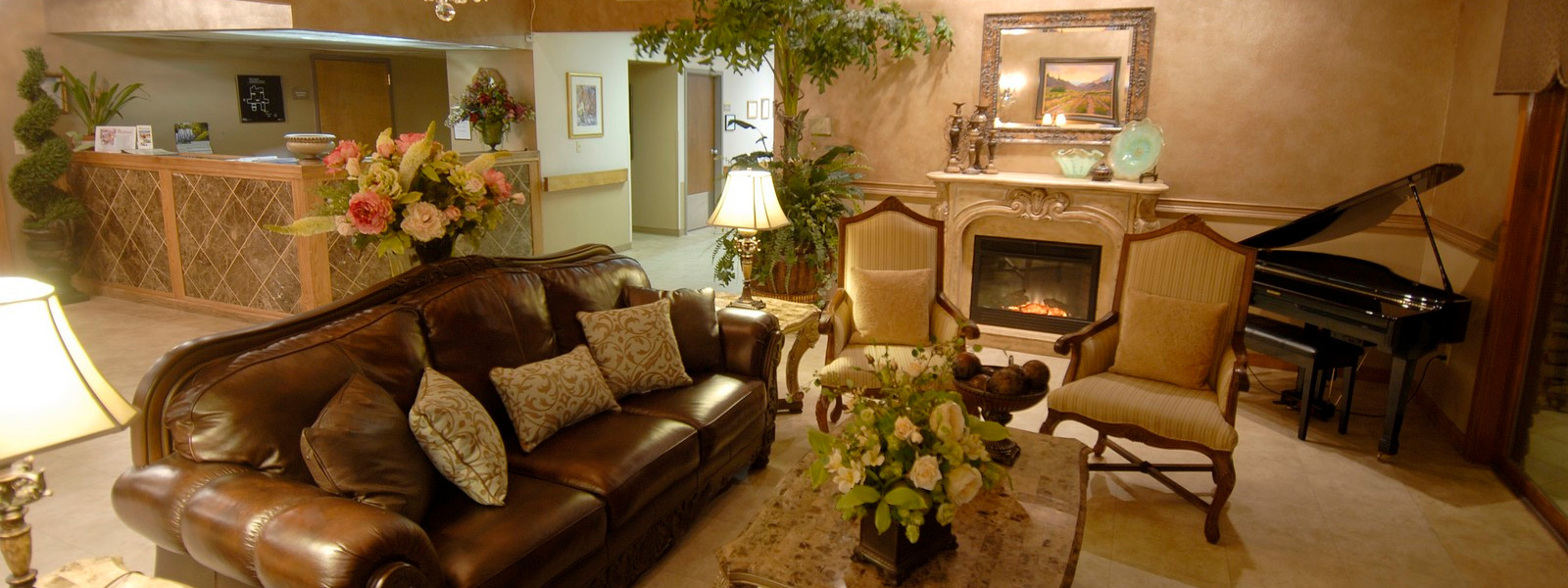 Beautifully decorated lobby and holiday tree sparkling by the fireplace