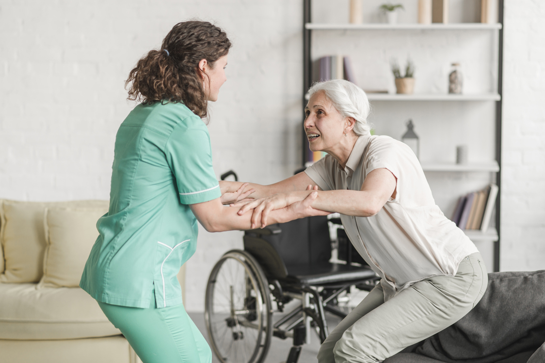 nurse helping woman in a wheelchair