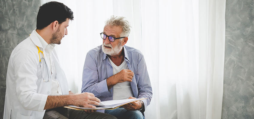 A doctor going over paperwork with a patient.